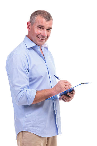 istock casual middle aged man writes on clipboard 176192184