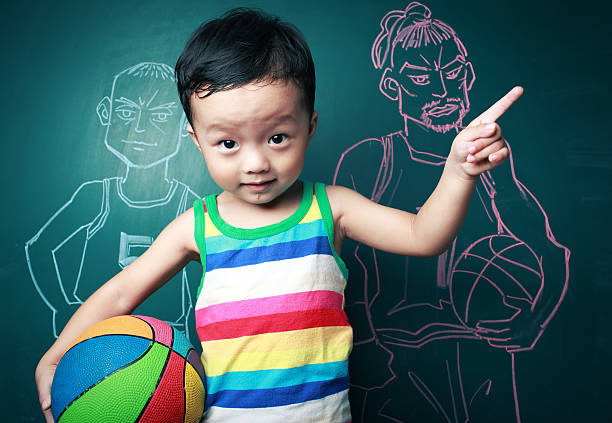 istock cute little boy playing basketball 176193185