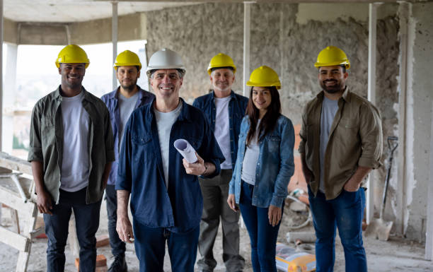 istock Group of construction workers smiling at a building site 1761958183