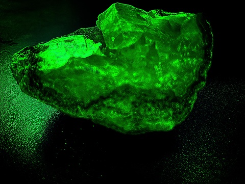 A Green Crystal Glows In The Darkness