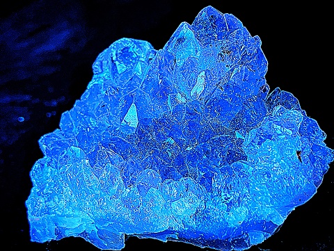 A blue crystal glows in the dark