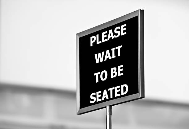 Please Wait To Be Seated Sign stock photo