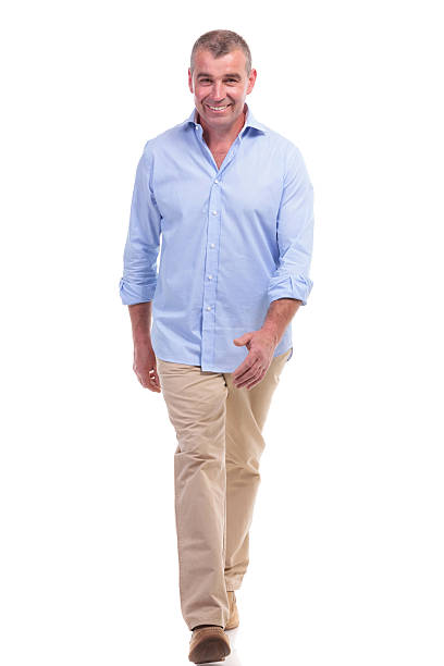 istock casual middle aged man walks to the camera 176201994