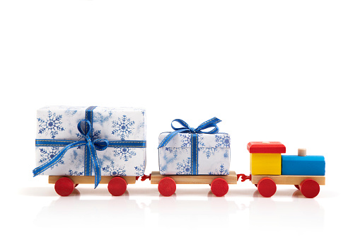 Wooden colorful toy train with gifts isolated on white background