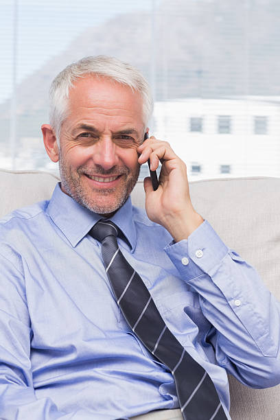 istock Smiling businessman calling on smartphone 176206301