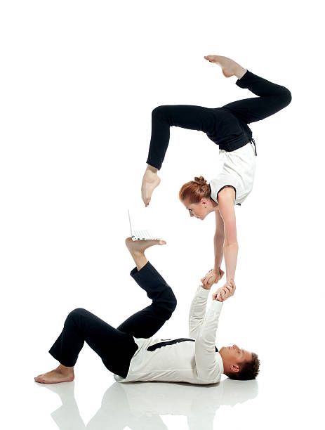 geschäftsleute yoga mit computer, isoliert auf weiss - flexibility business gymnastics exercising stock-fotos und bilder