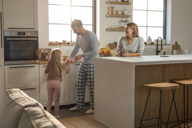 istock Young cheerful family having fun at kitchen 1762096216
