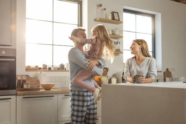 istock Young cheerful family having fun at kitchen 1762096218