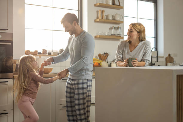 istock Young cheerful family having fun at kitchen 1762096221