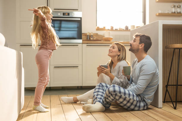 istock Young cheerful family having fun at kitchen 1762096735