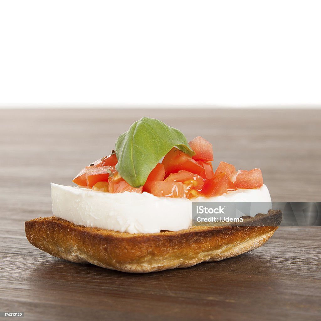 Fresh and tasty bruschetta Fresh and tasty bruschetta on a wooden table Appetizer Stock Photo