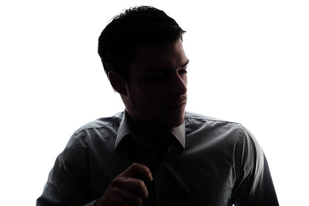 istock Businessman silhouette loosen a bit the tie after work 176217433