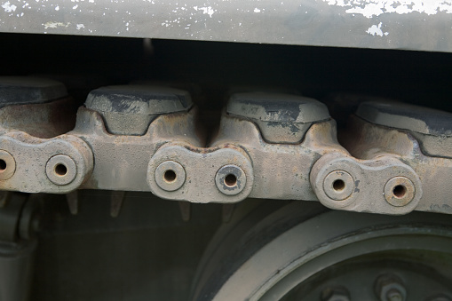 This is a side view of a tank track. Tis could be used in industrial designs or backgrounds that need grunge. The pins and chain section are shown in this image.