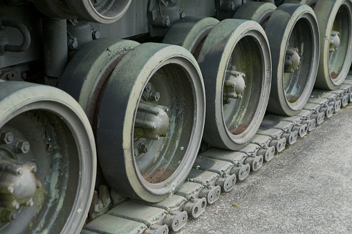 This is a line of wheels on the lower portion of a tank track. This shows a repeated pattern of circles for backgrounds or an industrial look.
