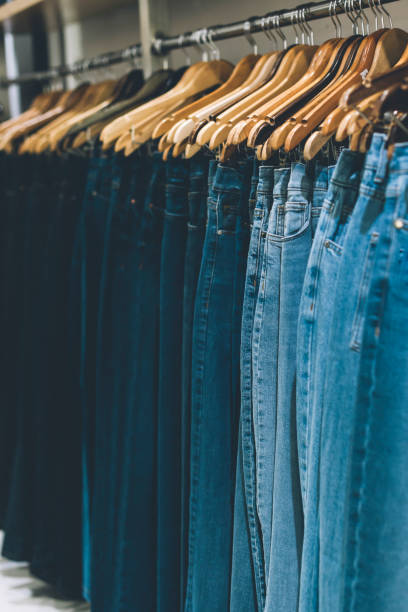istock Jeans hanging on a rack in a store. 1762198285