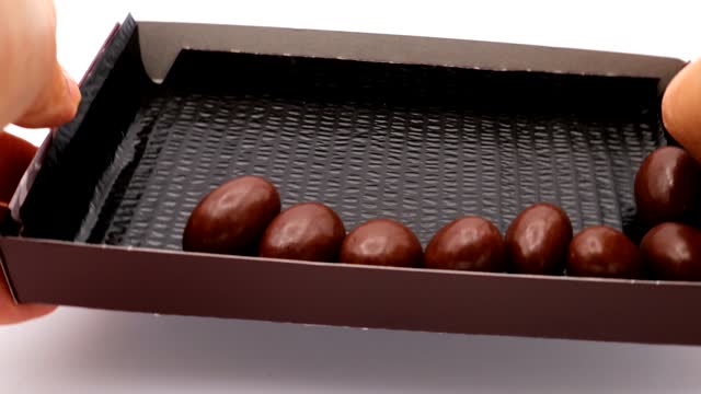 Video of a person rolling almond chocolate