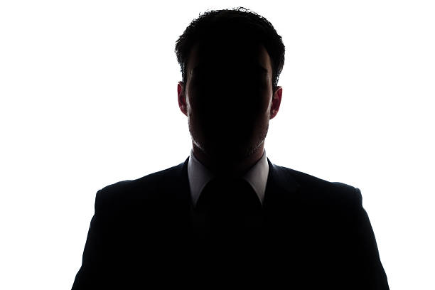 retrato de um empresário e uma silhueta misteriosa rosto - silhouette  fotos imagens e fotografias de stock