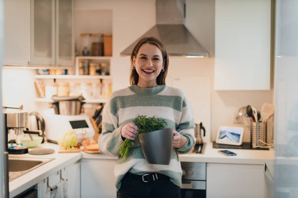 istock Young woman separating compost waste in the kitchen at home 1762217989