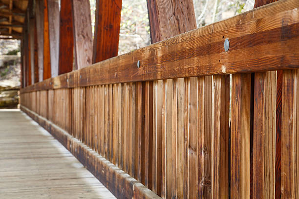 An old wooden, covered bridge in springtime forest