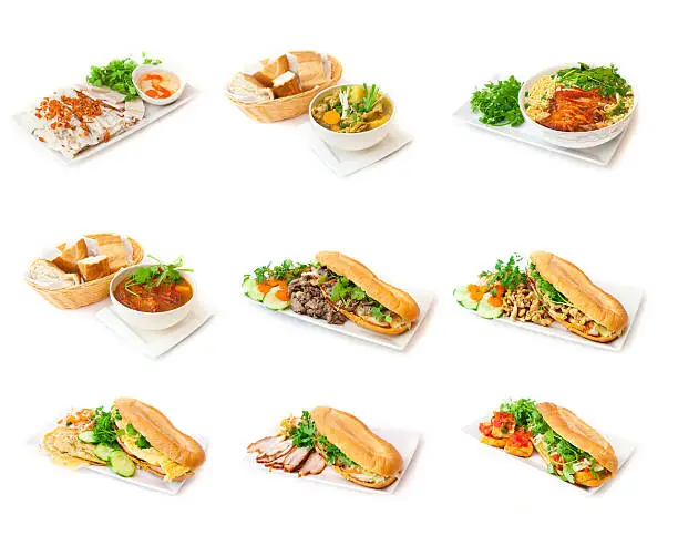 Vietnamese dishes on the white background. On white plates you can see sandwiches called Bánh mì with meat, egg, coriander, carrot, cucumber and fresh baguette and special Chinese soups with pepper tomatoes and grilled chicken. All given with  green vegetables, like chives and parsley.