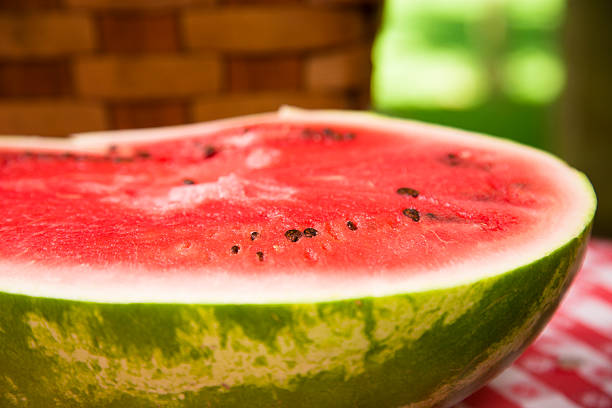 istock Food:  Fresh red ripe watermelon on traditional checked picnic tablecloth. 176228009