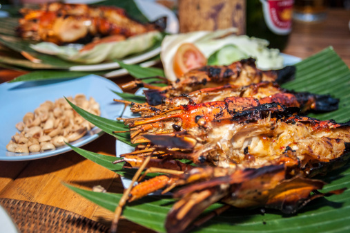 Grilled lobster on the shell sitting on a banana leaf.