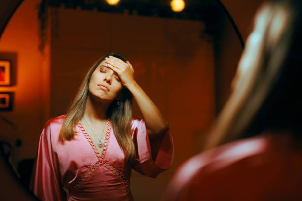 istock Unhappy Woman Looking in the Mirror Feeling Depressed 1762301361