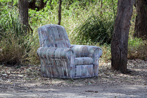 Sofa chair armchair dumped by the roadside in the Australian bush