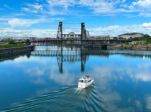 View of the historic vertical lift Steel Bridge and Willamette River from downtown Portland, Oregon.