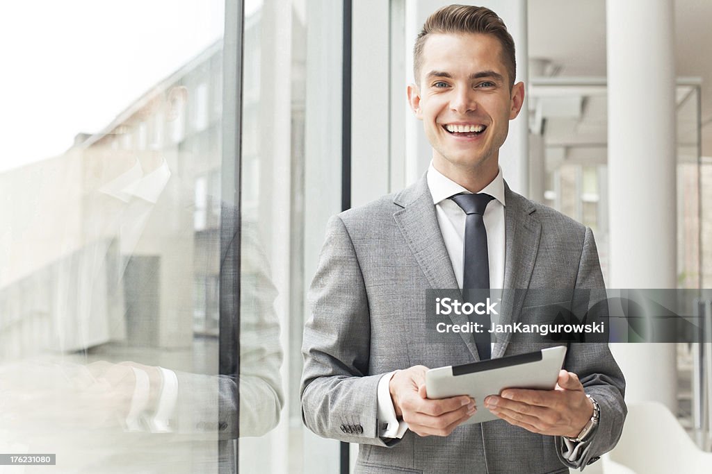Handsome businessman Handsome yuppie in a business setting smiling at the camera. 30-39 Years Stock Photo