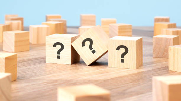 istock three wooden cubes with question marks over a blue background with copy space 1762348313