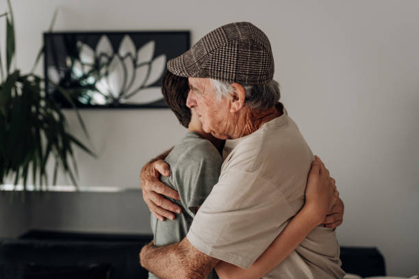 istock Grandfather hugging grandson at home 1762355800
