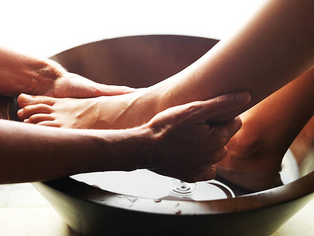педикюр-женщина ноги, получающих массаж ступней - мыть фотографии стоковые фото и изображения