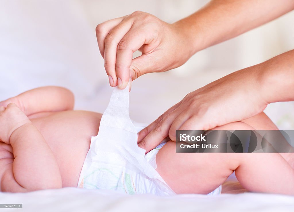 Making sure it's fastened correctly  Diaper Stock Photo