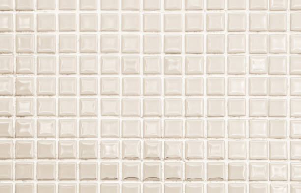 istock Cream light ceramic wall and floor tiles mosaic background in bathroom and kitchen. Design pattern geometric with grid wallpaper texture decoration pool. Simple seamless abstract surface clean. 1762389463