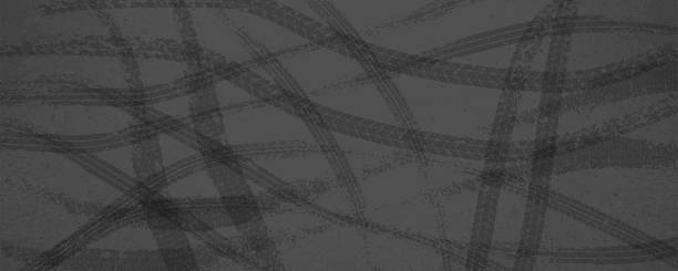 Parallel tire skid marks on a dark gray asphalt road Parallel tire skid marks on a dark gray asphalt road. Abstract vector background with grunge texture car drift stock illustrations
