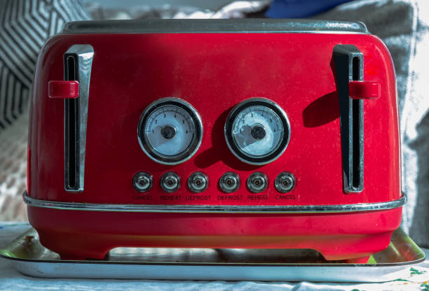 Red retro styled toaster for breakfast. Toaster in vintage style. Red retro styled toaster for breakfast. Toaster in vintage style, Electric stainless steel toaster, Selective focus. kitchen utensil antique toaster old stock pictures, royalty-free photos & images