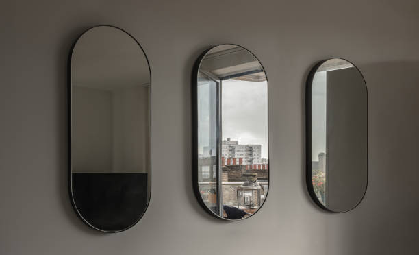 istock View of Three Capsula pill shaped mirror on white wall. 1762399608