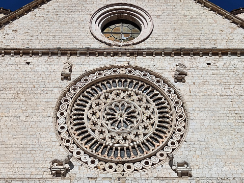 Rose window at the Basilica di San Francesco d'Assisi, a town in the Umbria region in central Italy, where Saint Francis was born and died. It is one of the most important places of Christian pilgrimage in Italy. The basilica is a distinctive landmark and has been a UNESCO World Heritage Site since 2000.
