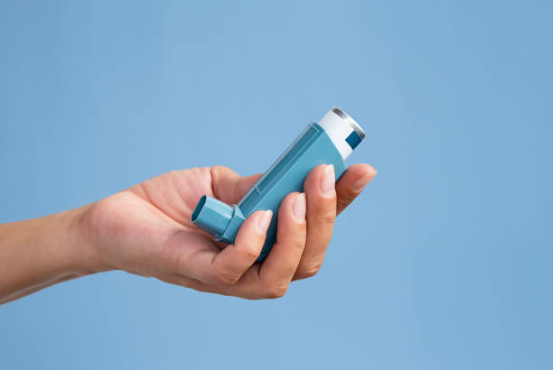 istock Human hand holding medicine asthma inhaler. 1762593555