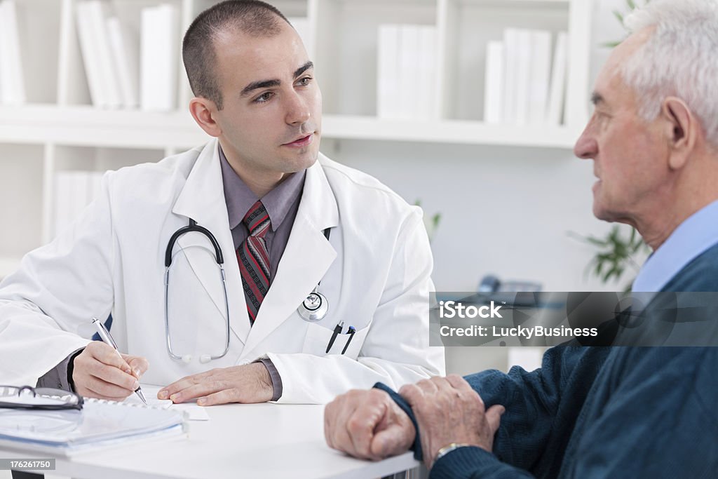 patient with doctor doctor explaining diagnosis to his male patient. 70-79 Years Stock Photo