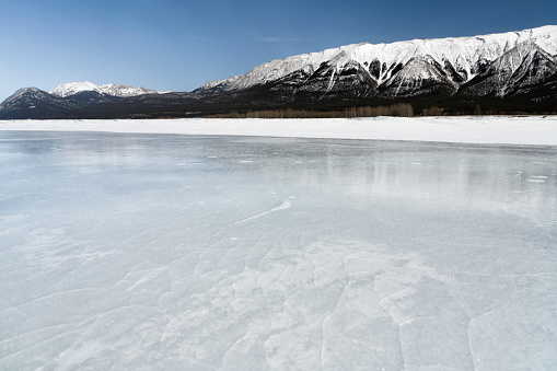 Frozen icy Abraham Lake in late winter March, Alberta, Canada