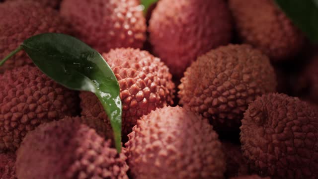 Lychee fruit. Close-up camera moving down and shows lot of fresh lychee fruit