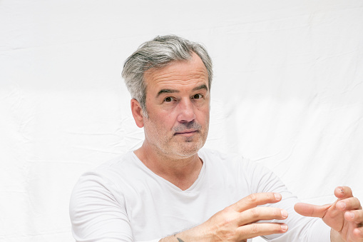 Handsome man portrait, wearing casual t-shirt. Gray-haired adult male.