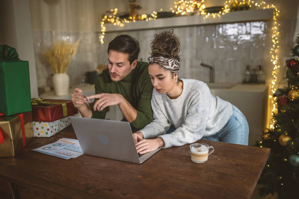 Young couple managing finances at home