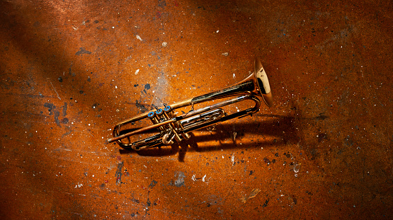 Broken trumpet on floor