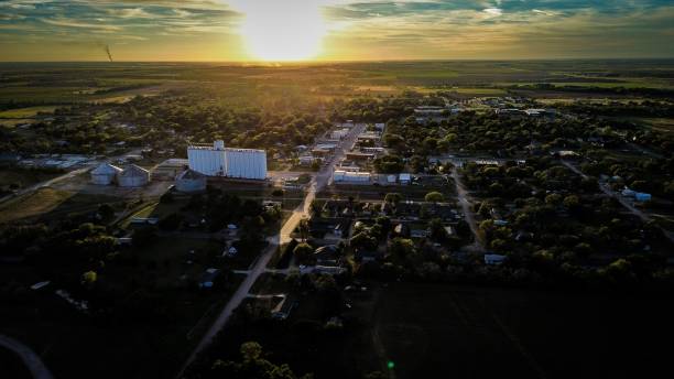 istock the sun is setting over a city and several trees in front 1762741859