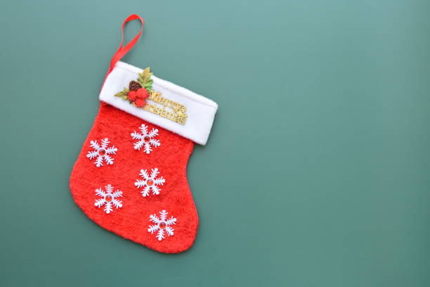 istock red wool winter sock on green background, christmas decoration 1762790280