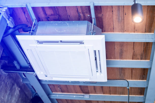 istock Selective focus to Ceiling mounted cassette type air condition units with other parts of ventilation system with hanging lights and other construction parts in vintage office. 1762826523