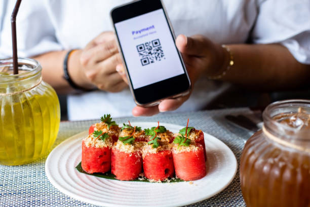 istock Selective focus to Thai food that uses watermelon as the main ingredient with blurry simulate QR code tag on smartphone. 1762827616